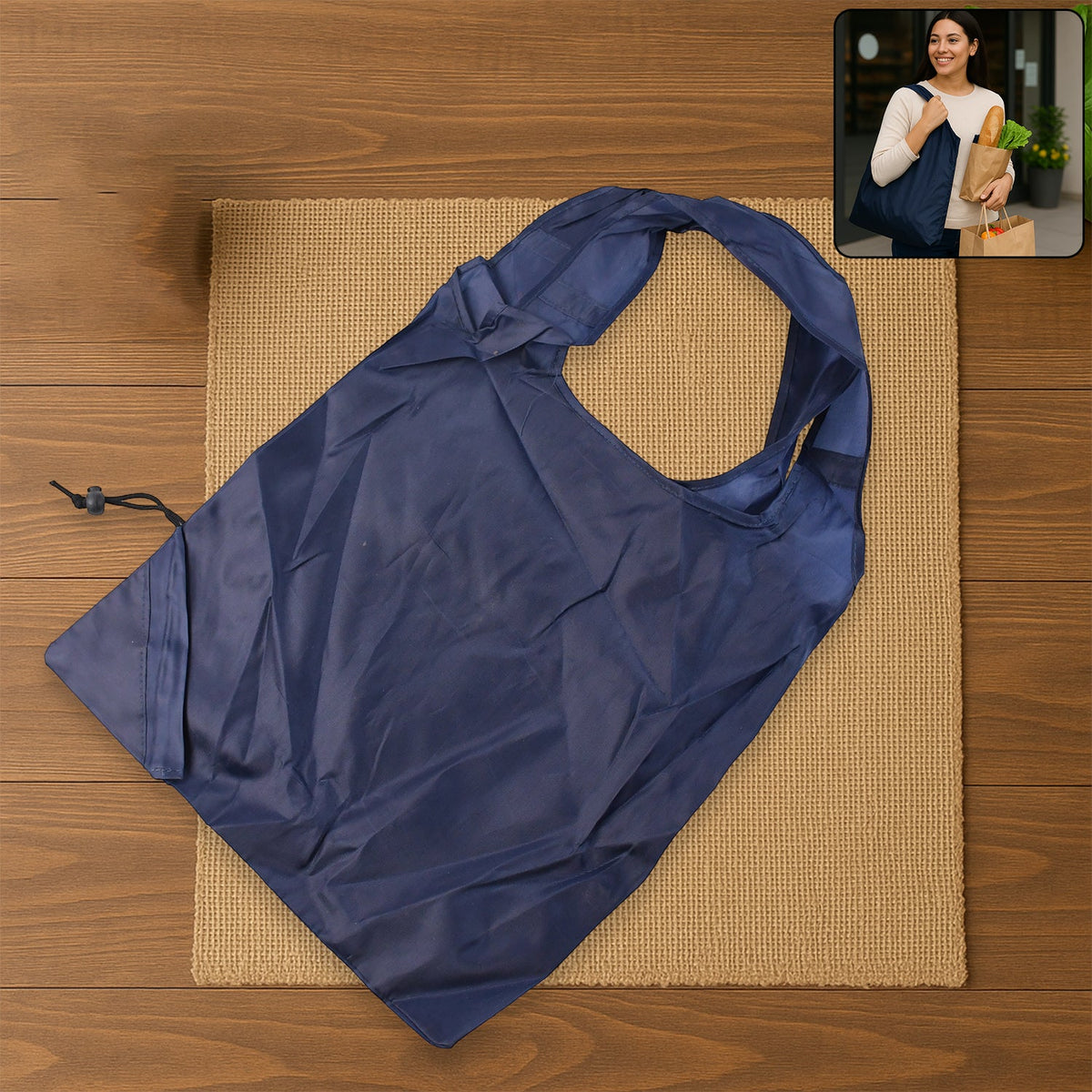 A dark blue reusable shopping bag lies on a brown mat, with an inset image of a woman carrying a similar bag.
