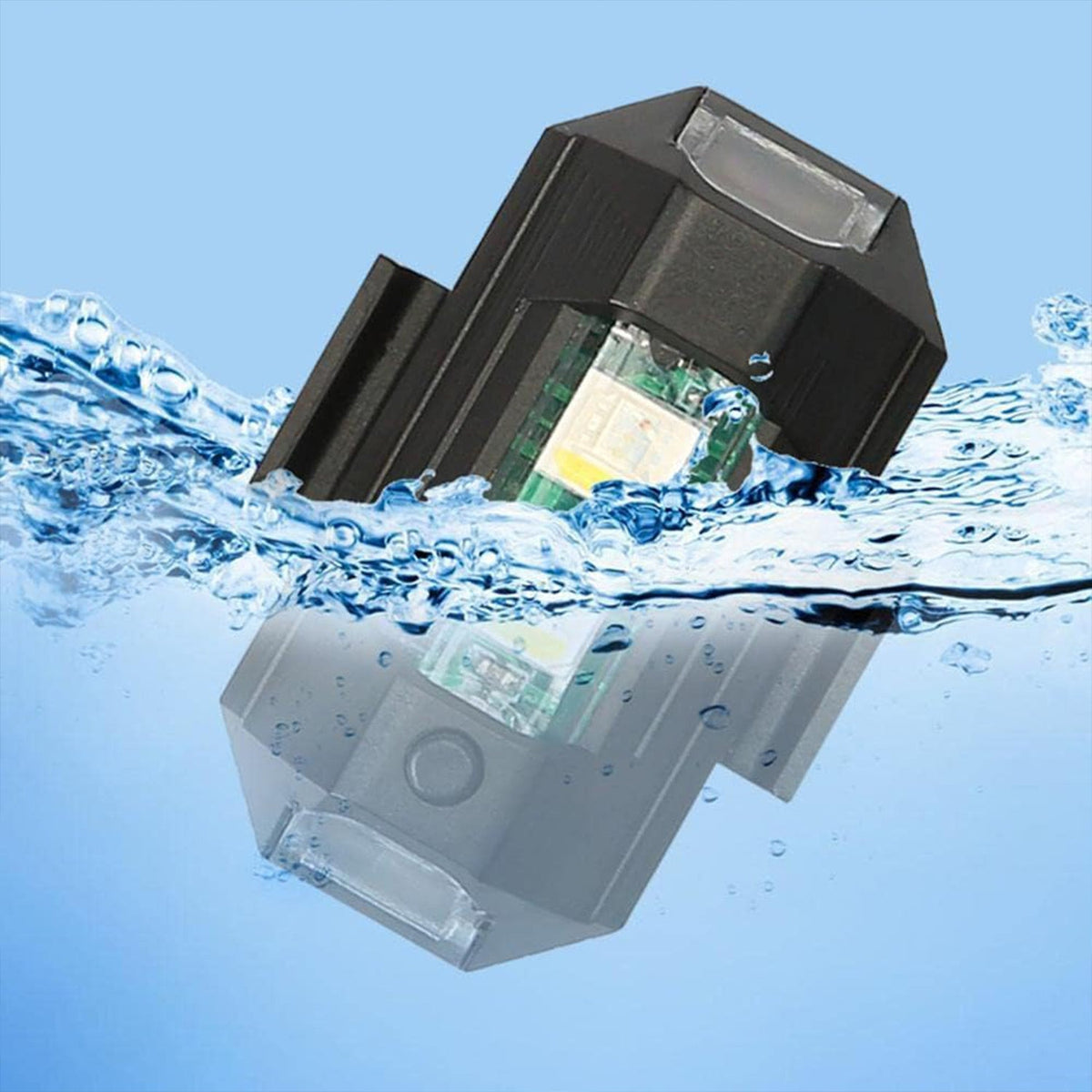 Black LED strobe light partially submerged in water, showing its waterproof feature with a reflection below.