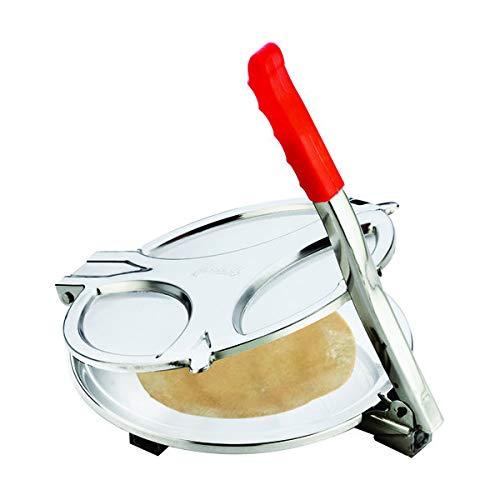 A stainless steel puri press with a red handle is open, revealing a piece of dough inside.