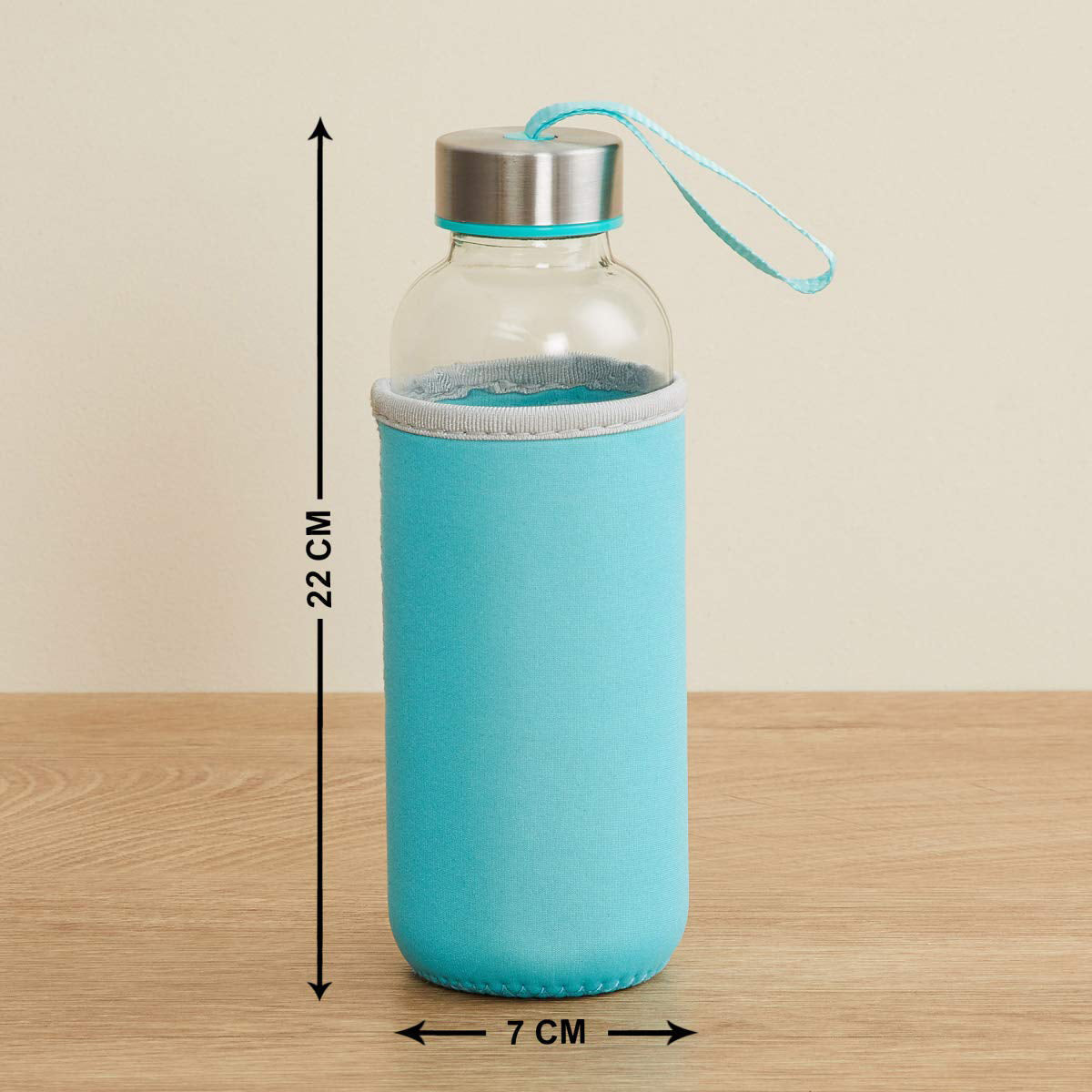 A clear glass bottle with a turquoise sleeve and lid, with dimensions of 22cm high and 7cm wide.