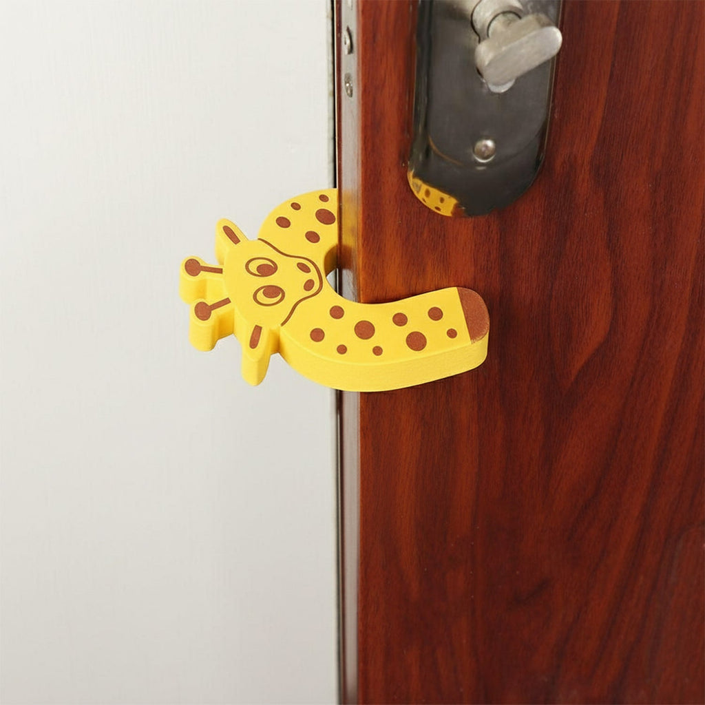 A yellow giraffe-shaped EVA door stopper is shown from a different angle, wedged on a brown door.