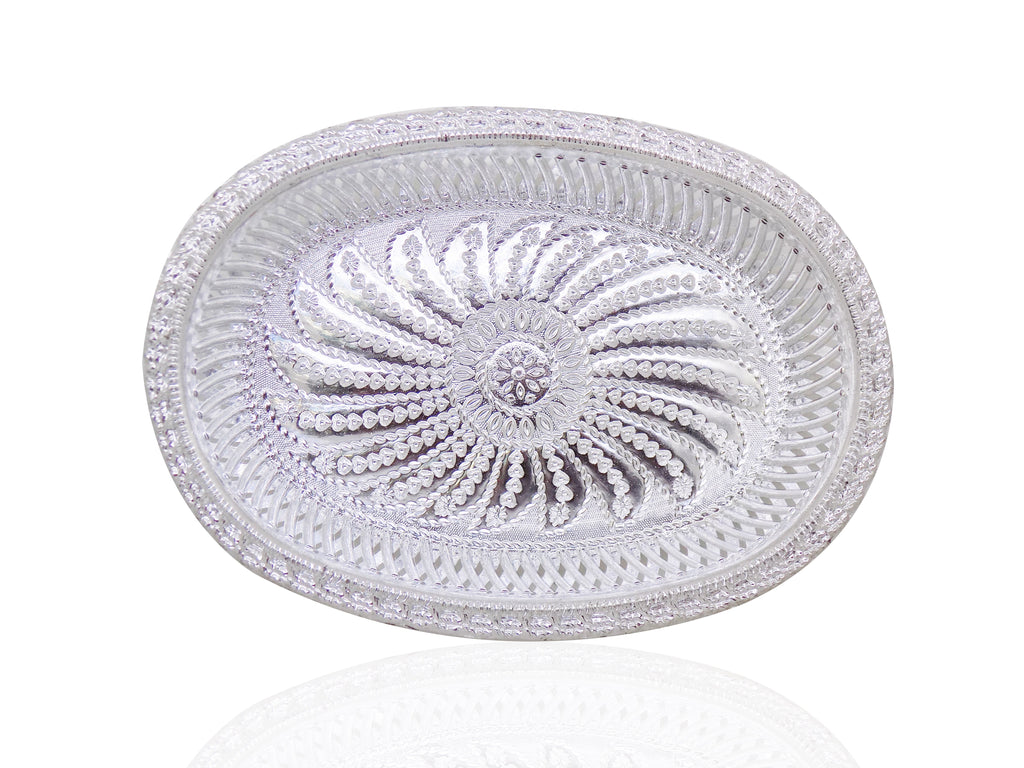 A silver oval decorative serving tray with an intricate floral pattern, viewed from directly above.
