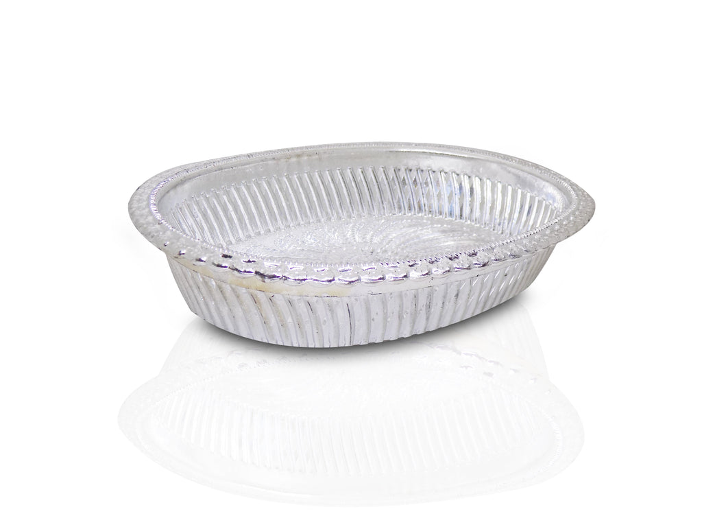 A silver oval decorative serving tray with a floral pattern on a white background with a reflection.