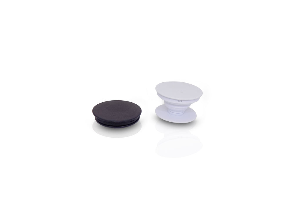 A black collapsed phone grip and an expanded white phone grip are displayed side-by-side on a white surface.