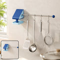 Blue and light blue wall-mounted drying rack with a silver rod holding kitchen utensils. Inset shows the rack without