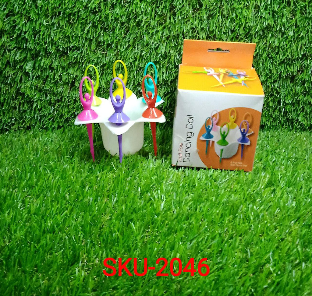 Six colorful dancing doll fruit forks in a white flower stand next to their product box on green artificial grass.